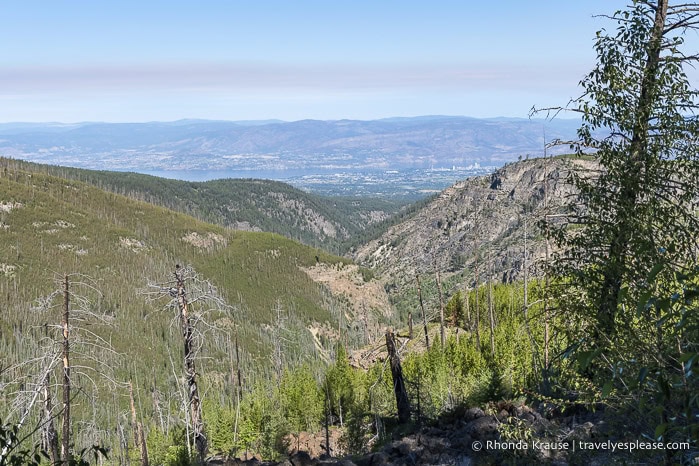 Myra Canyon with Kelowna and Okanagan Lake in the distance.