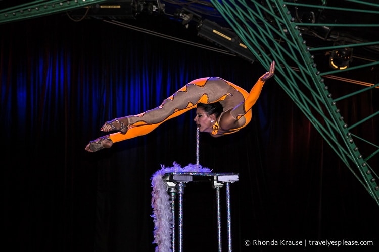 Contortionist balancing on a pole.