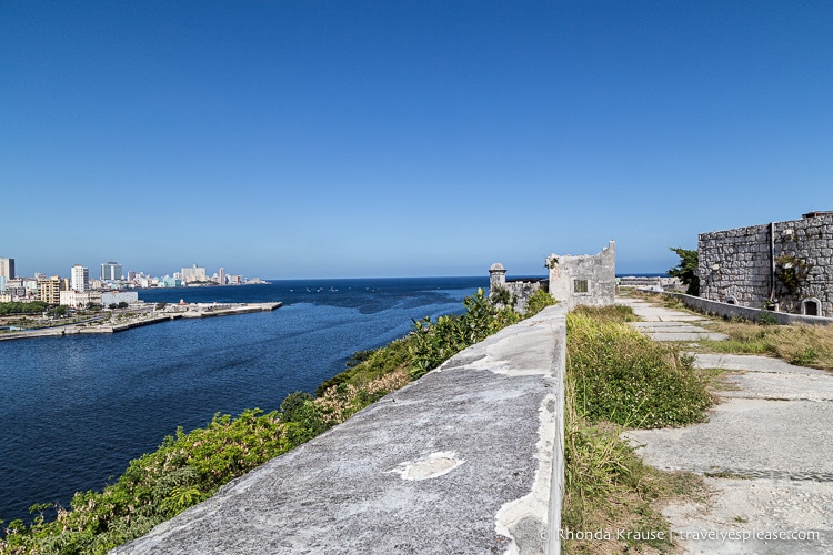 Stone wall of La Caba~na with Havana in the background.