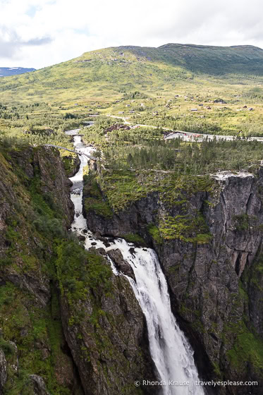 Voringsfossen and the Bjoreio River with a hill in the background.