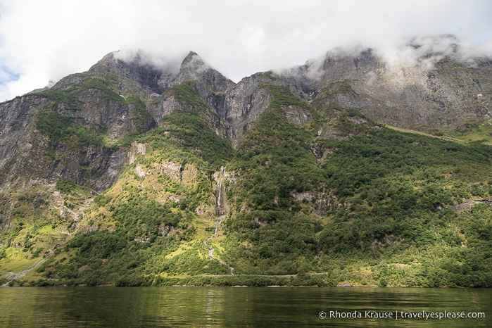 Forested mountain with waterfalls in Naeroyfjord.