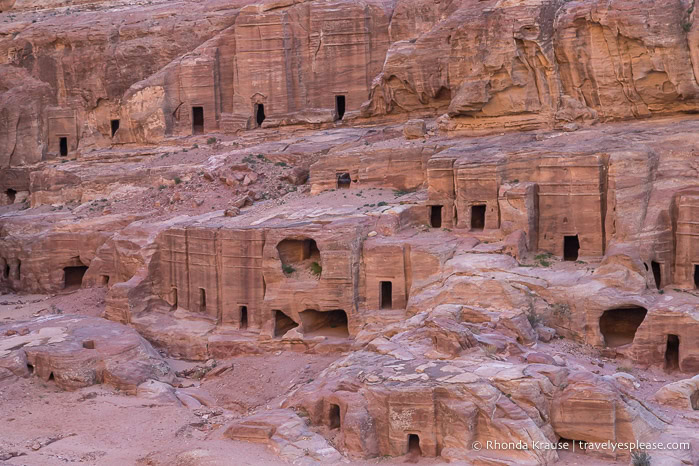Rows of tombs carved into the red rock.